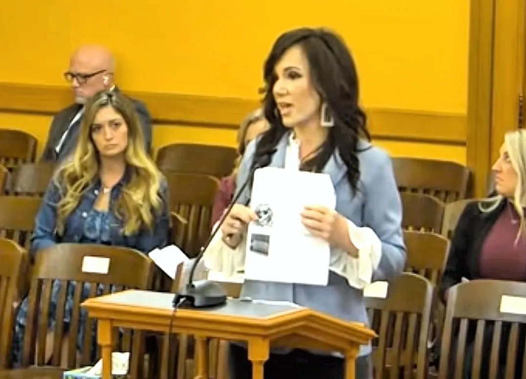 Meg speaking at the Kansas Capitol with documents, March 6, 2026