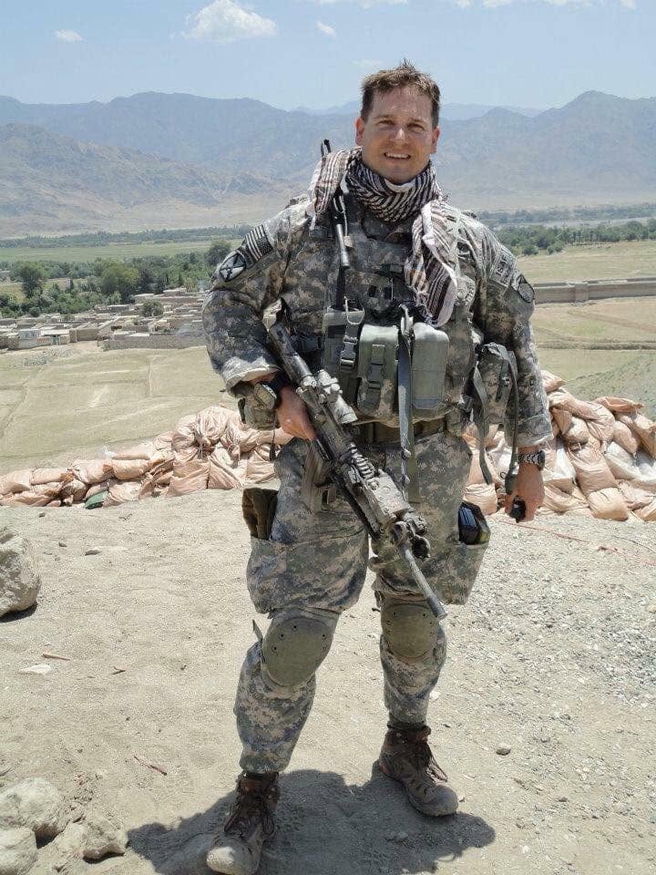 Shawn Lee in U.S. Army combat uniform with tactical gear in a deployed environment
